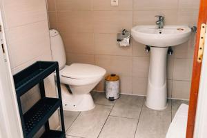 a bathroom with a toilet and a sink at 5 Swiss Hotel in Kigali +29 photos
