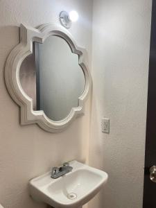 a bathroom with a sink and a mirror on the wall at Blue Beach 2 min to Miramar Beach in Ciudad Madero +30 photos