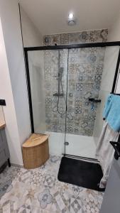 a bathroom with a shower with a bench in it at Maison élégante entre Ré et Marais in Marans +25 photos