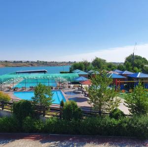 a resort with two pools and umbrellas at Boat Station in Kapchagay