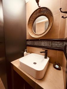 a bathroom with a white sink and a mirror at Garden villa two-bedroom suite in Vari +35 photos