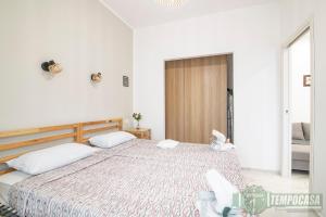 a bedroom with a large bed with two white pillows at Regina in Sesto San Giovanni
