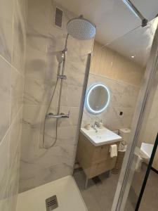 a bathroom with a shower and a sink at Downtown Limoges - Secure parking in Limoges