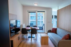 a living room with a couch and a table with chairs at Apartmán Vilda in Dolní Morava