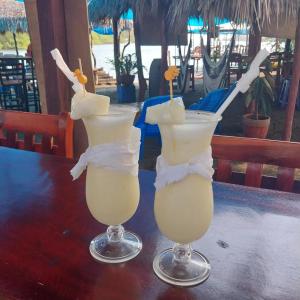two cocktails sitting on top of a table at Mangrove Island Cabanas in Poneloya