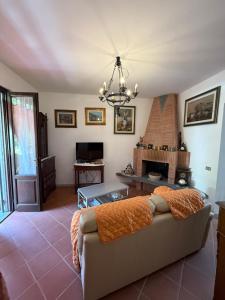 a living room with a couch and a fireplace at Casolare De Ranieri - appartamento in villa bifamiliare a 500m dal mare in Marina di Massa