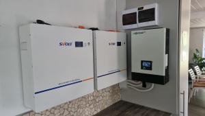 a room with two refrigerators and a microwave at DullVino First House in Dullstroom