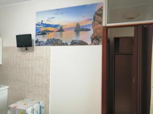 a bathroom with a picture of the ocean on the wall at Acirealevacanze - Romantica Camera sul Mare in Acireale