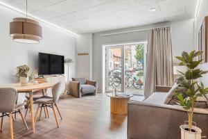 a living room with a couch and a table at Ground-Floor Living with Stylish Nordic Interiors in Aarhus