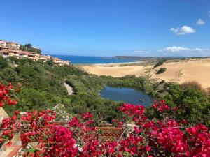 a lake on a hill with pink flowers at Casa Vacanza Suite Violet in Torre Dei Corsari