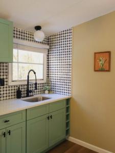 une cuisine avec un évier et une fenêtre dans l'établissement Riverfront Cottage with Sauna & Hot Tub, à Liberty