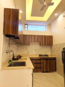 a kitchen with a sink and a ceiling fan at The Hills & Waves in Rishīkesh +25 photos