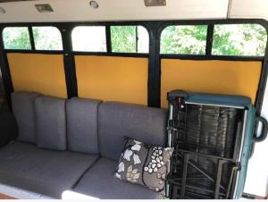 Ruang duduk di Covered Bridge Tiny Home Bus On The Water In Rrg