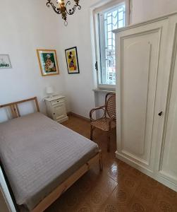 a bedroom with a bed and a window and a door at Casa da Oscar in Marcelli