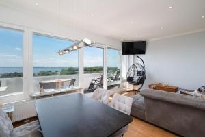 a living room with a couch and a table at Panoramic App C09-8 in Sierksdorf