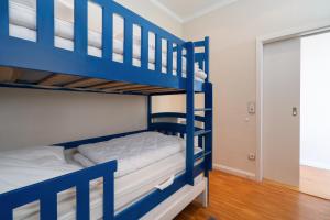 a bunk bed room with blue bunk beds at Panoramic App C09-8 in Sierksdorf +24 photos