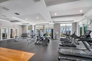 a gym with a lot of treadmills and machines at Casa Costa 309N 1 Bedroom, Pools, Jacuzzi, Beach, Shops & Dog Friendly in Boynton Beach