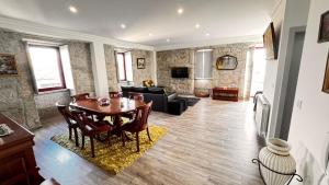 a living room with a table and a couch at Casa das Antas in Antas
