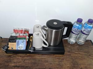a tray with a coffee maker and some water bottles at Premium Serviced Accommodation Rooms Nottingham - All with Ensuites in Nottingham