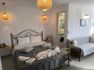a bedroom with a bed and a washing machine at Skopelos Sunset traditional country house in Panormos Skopelos