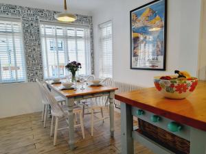 a dining room with a wooden table and chairs at Crab Cottage in Ilfracombe