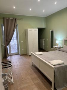 a bedroom with a large bed in a room at Don Mimì Casa Vacanza in Torre del Greco