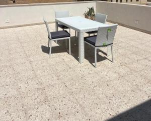 a table and two chairs on a patio at Ramò Apartments in Canicattì