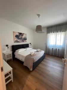 a bedroom with a large bed and a window at Ramò Apartments in Canicattì