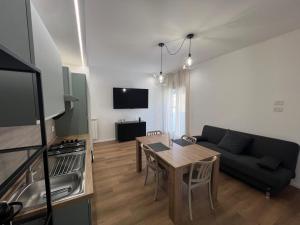 a living room with a table and a couch at Ramò Apartments in Canicattì