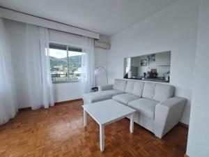 a living room with a couch and a table at Sofias Seaview Appartment in Paleo Tsifliki
