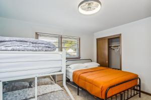 a bedroom with two bunk beds and a window at HotTub, Cinema & Games in a Quiet Neighborhood in Wichita