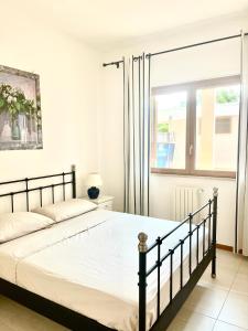 a bedroom with a bed and a window at Polignano Villa with Jacuzzi, Garden & Parking in Polignano a Mare +22 photos