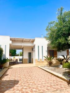 a patio of a house with a brick driveway at Polignano Villa with Jacuzzi, Garden & Parking in Polignano a Mare