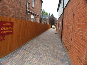 a brick alley with a sign on the side of a building at Ashlea Guest House in Banbury