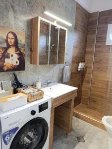 a bathroom with a washing machine and a sink at 3B House in Nea Vrasna +21 photos