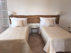 two beds sitting next to each other in a room at Villa Charme in San Marzano sul Sarno