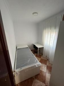 a small room with a bed and a table at Balneario Cachucha in Puerto Real