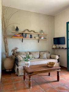 a living room with a couch and a coffee table at AMPELIA KYTHIRA in Livadi