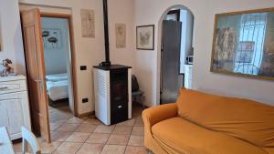 a living room with a couch and a stove at Casa vacanza Auronzo in Auronzo di Cadore