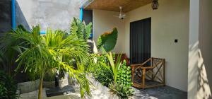 a room with plants in front of a house at Madi Beach Guesthouse in Maalhos