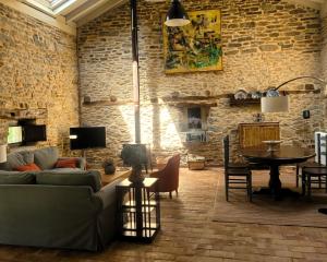 a living room with a couch and a table at La cabaña de San Pelayo in San Pelayo