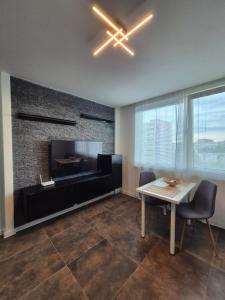 a living room with a table and a fireplace at Apartmán v centre mesta Levice,Okružná in Levice