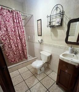 a bathroom with a toilet and a sink at Jireh guesthouse in Antigua Guatemala
