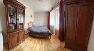 a room with a bed and a wooden floor at Затишок в Карпатах in Skole