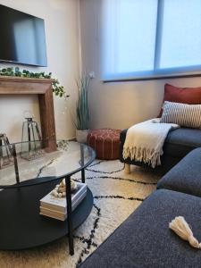 a living room with a couch and a table at Cosy Flat with IPTV, BB gear Married couples only in Tangier +36 photos