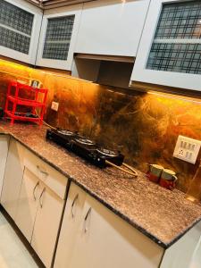 a toy train on a counter in a kitchen at Night View Apartment in Ghaziabad +40 photos