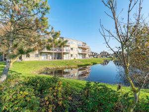 a building on the side of a river at Apartment in Julianadorp near the beach in Julianadorp