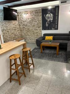 a living room with a couch and two stools at House Sela vrata in Bibinje