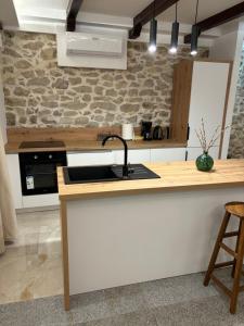 a kitchen with a sink and a counter at House Sela vrata in Bibinje