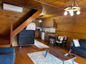 a living room with a couch and a table at Qzen Bungalow in Yomra